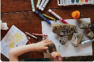 Child making art with paper and colors